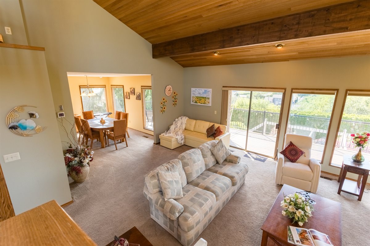 Great room with dining area and deck views